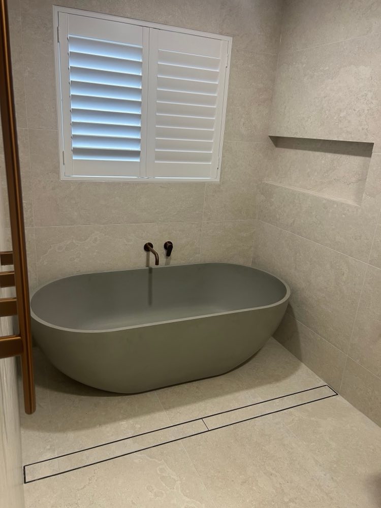 Hawker bathroom with a freestanding bath and shuttered window